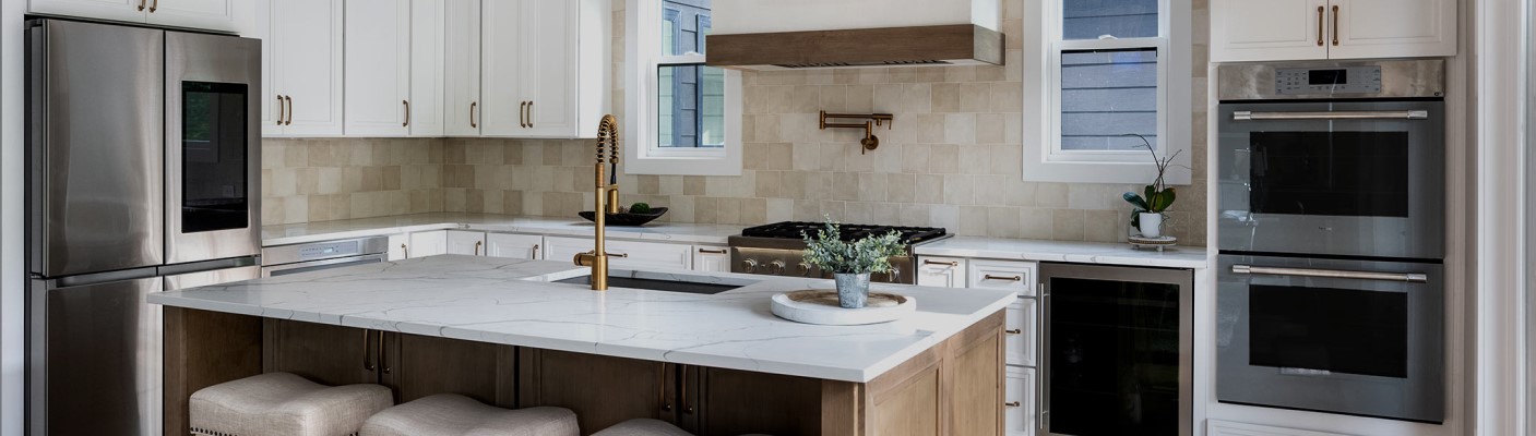 Built-in wall ovens and a range in a fitted kitchen