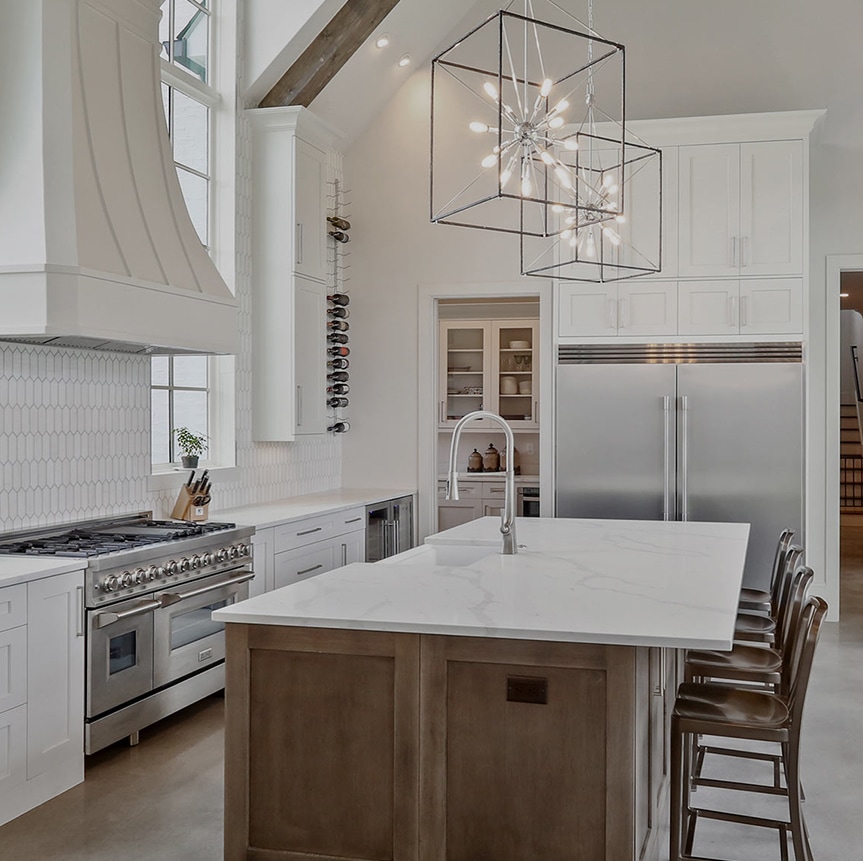 Kitchen with custom cabinetry, stone countertops and a wide island